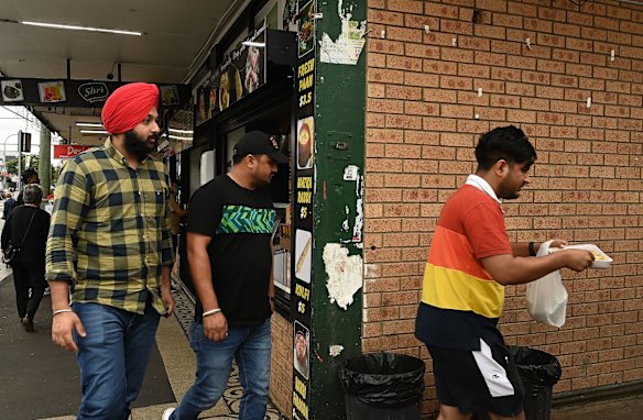 Customers head for a restaurant's outdoor dining area.