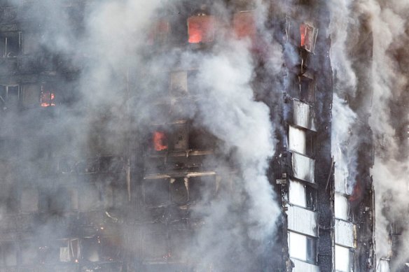 Smoke billows from the high-rise apartment building in west London.
