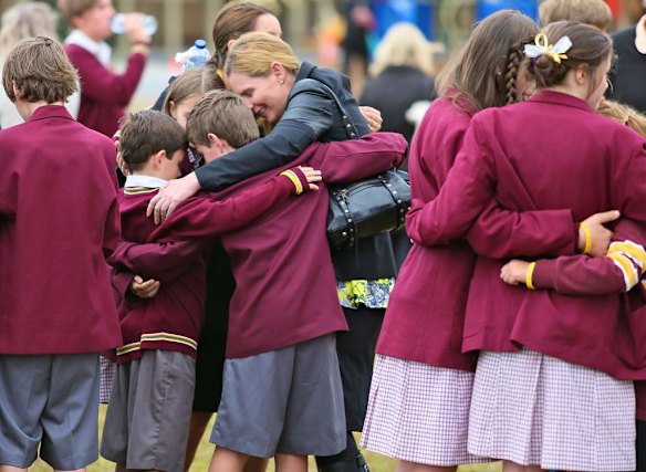 freinds from the school console each other after the service.