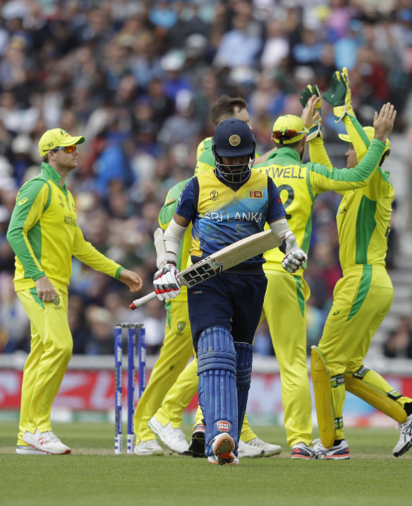 Australian players celebrate taking the wicket of Sri Lanka's Lahiru Thirimanne.