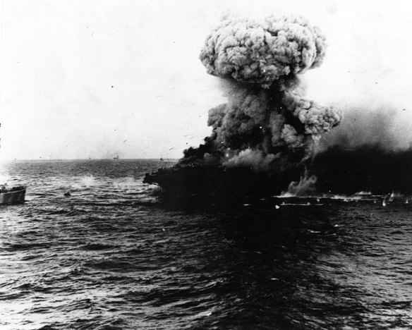 A mushroom cloud rises after a heavy explosion on board USS Lexington, 8 May 1942. 