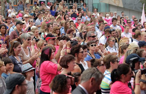 Fans celebrate Samuel Johnson crossing the finish line after his year-long Love Your Sister unicycle trek.