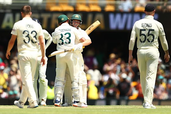 Marcus Harris of Australia and Marnus Labuschagne of Australia celebrate winning during day four of the First Test Match in the Ashes series between Australia and England at The Gabba.
