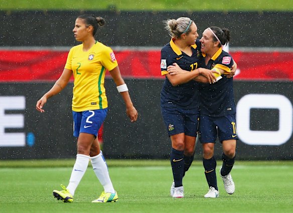 Fabiana of Brazil looks dejected as Kyah Simon of Australia celebrates with teammate Lisa De Vanna.
