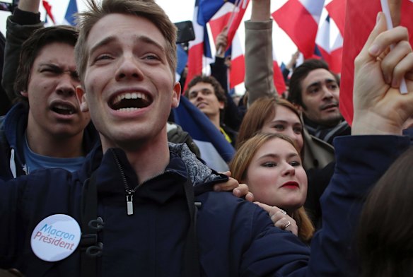 Supporters of French independent centrist presidential candidate, Emmanuel Macron celebrate outside the Louvre museum in Paris.