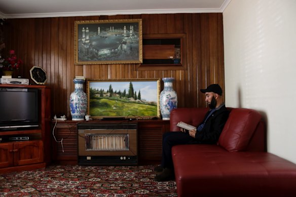 Polat Abdulla recites the Koran in his Adelaide home.