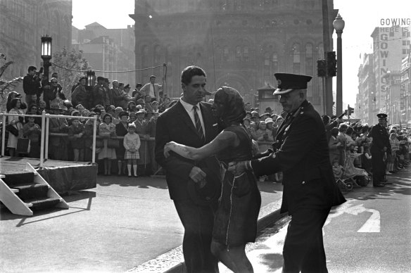 “Anti-war protester Nadine Jensen, a typist from Campbelltown, is restrained by a police officer after covering herself in red paint during the return march in Sydney for the 1 RAR, after they returned from active duty in Vietnam. ”