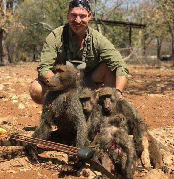 Idaho Fish and Game Commissioner Blake Fischer poses with 'a whole family of baboons' he says he shot on a recent hunting trip in Africa.
