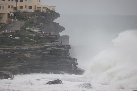 The surf's well and truly up at high tide on Bondi Beach.