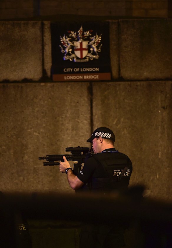 An armed Police officer looks through his weapon on London Bridge.