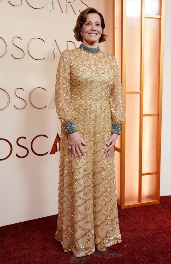Sigourney Weaver channels an Academy Award in a classic gold gown.