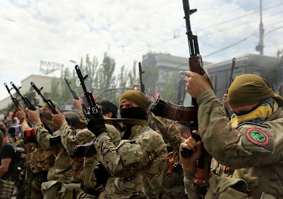 Pro Russian rebels fire their weapons in the streets of Donetsk during the war in East Ukraine. Donetsk, East Ukraine, May, 2014.