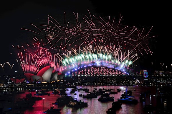 The New Years Eve Midnight fireworks light up the Sydney Harbour Bridge and Opera House.