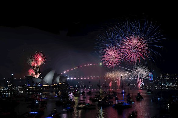 The New Years Eve Midnight fireworks light up the Sydney Harbour Bridge and Opera House.