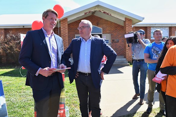 Dan Hayes and Luke Foley have a quiet word at the Glenfield Park Scout Hall booth.