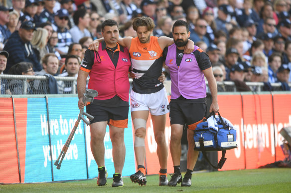 Callan Ward is assisted from the field after the first quarter injury.