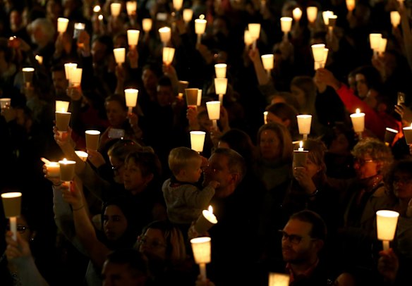 People hold candles up in support of refugees on September 7, 2015 in Sydney, Australia. 