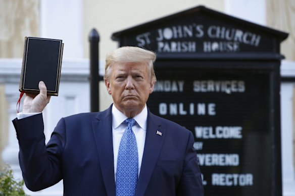 President Donald Trump holds a Bible outside St John's Church across Lafayette Park from the White House, in Washington. Reports of hateful and violent speech on Facebook poured in on the night of May 28 after Trump hit send on a social media post warning that looters who joined protests following Floyd's death last year would be shot.