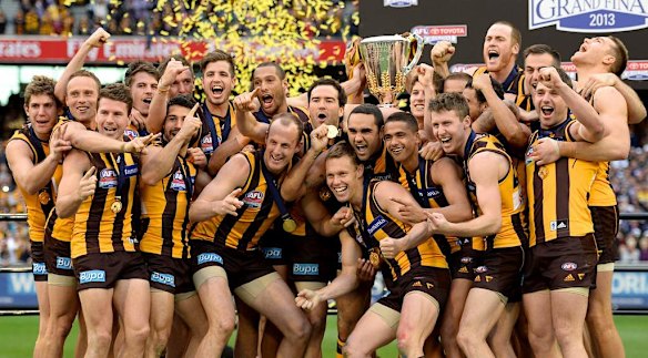 Hawthorn players celebrate winning the 2013 AFL Premiership.