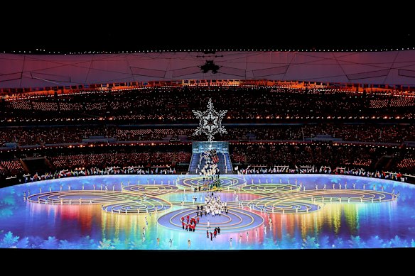 Athletes make their way around the Beijing National Stadium during the closing ceremony.