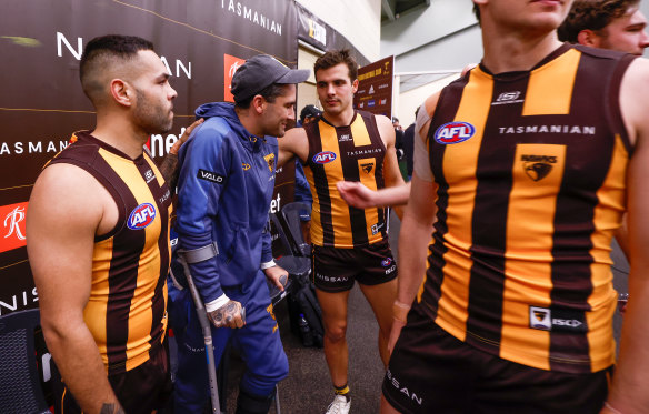 Bitter blow: Chad Wingard is consoled by teammates in Launceston last Sunday.