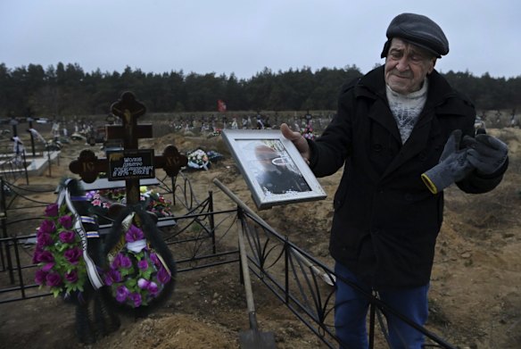 At the Matviyivka new cemetery, Oleksandr Zholob, 71, holds a photo of his only child, Dmytro Zholob, at his grave. Dmytro was 46-years-old when he was killed on August 29 in a missile strike in Mykolaiv. He was walking back from a shop after tending to seven cats left behind by neighbours. A piece of shrapnel from the missile strike on residential buildings hit him in the head killing him instantly. He is survived by his wife and an 18 year-old-daughter.  