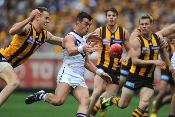 Fremantle's Ryan Crowley is chased by Hawthorn's Max Bailey.