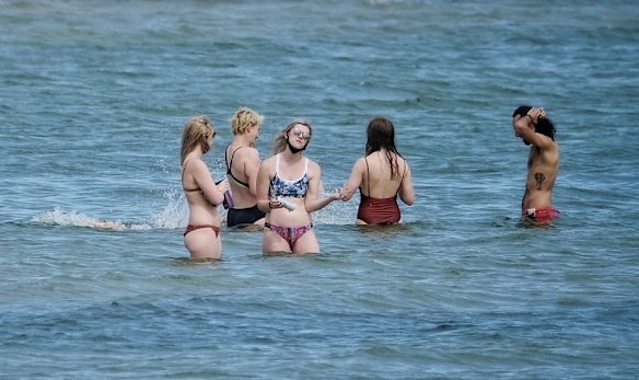 Masks and bikini's at St Kilda Beach.