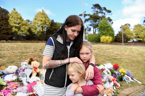 Felicity Miller was lost for words to comfort her daughters, Amelia and Felicia, as the family paid their respects to the victims of the Hillcrest Primary School tragedy. Amelia, 9, was at the end of year party at the school when a gust of wind lifted an inflatable castle ten metres into the air.