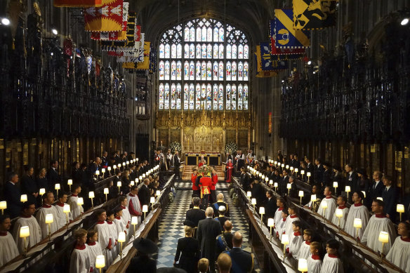 King Charles III and members of the royal family follow the coffin of Queen Elizabeth II as it is carried into St George’s Chapel for her committal service.