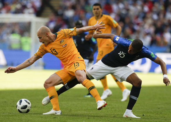 Aaron Mooy tussles with France's Kylian Mbappe in Australia's opening round defeat at the World Cup.