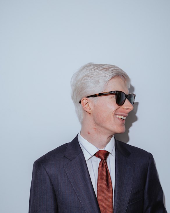 Maclean poses for a photo at the City of Parramatta council chambers with his accidentally JFK-inspired Saratoga sunglasses.