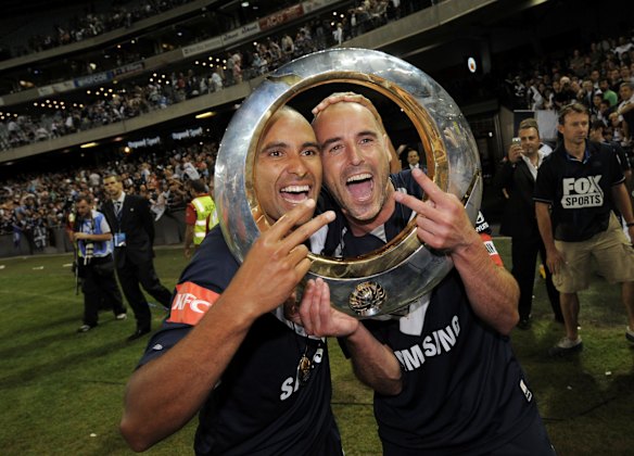 Toilet-seat trophy: With former teammate and current boss Kevin Muscat after winning the 2009 title.