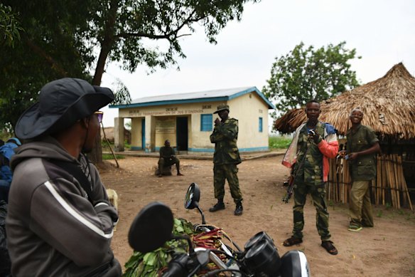 A man on a motorbike stops to talk with Armed Forces of the Democratic Republic of the Congo (FARDC) soldiers at a base near Kananga in Kasai Central. A United Nations Human Rights team have accused the FARDC of systematic human rights violations, some amounting to war crimes including committing mass killings, torture and rape in the war-torn Kasai region.