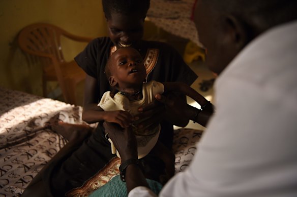 Nyereka Maliyah, 20, with her baby Dictor Geng, 1, who is ill and being treated at the CARE Stabalization point at Bentiu hospital, Bentiu, Unity State, South Sudan. 