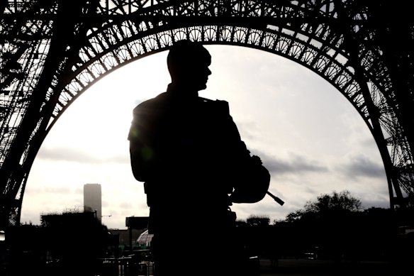 Armed military patrol the Eiffel Tower Paris, France.