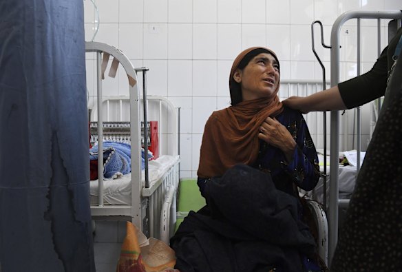 Tahera aged 40 years old is comforted moments after her three month old son Safiullah dies from severe acute malnutrition at the Mofleh Pediatric Hospital in Shaidayee area outside Herat city. 
