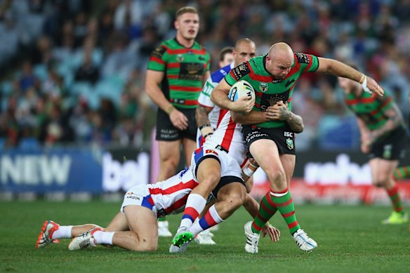 Ploughing ahead: Glenn Stewart drags a Knights defender along with him as he breaks the defensive line.
