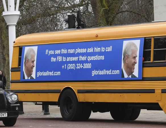 A yellow school bus with a message for Prince Andrew drives towards Buckingham Palace.