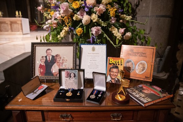 The display of personal memorabilia near the sacristy included Bert's autobiography, the album he and Patti recorded in 1977, his MBE and AM medals, a gold Logie, and a letter of appreciation from the Marist brothers.