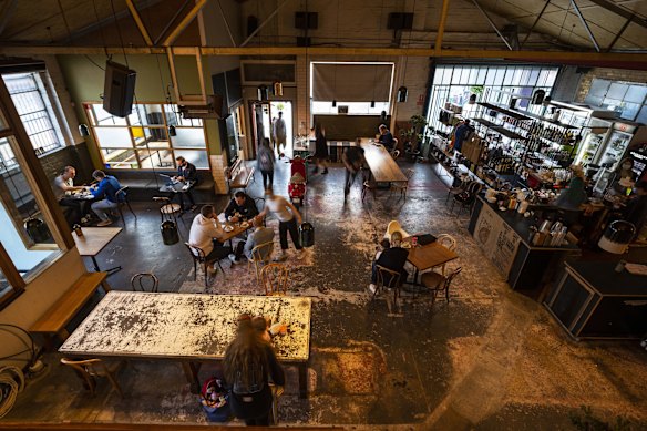 People are seen dining inside St. Ali Cafe in South Melbourne.