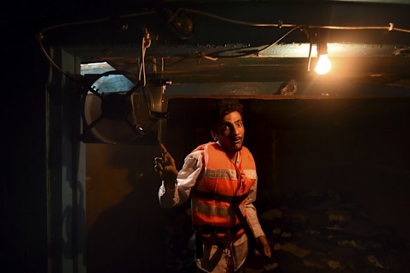 Mohamed from Pakistan stands in the hull of the wooden fishing boat that he shared with 150 people as he attempted to make the journey from Libya to Europe. The boat left Libya 12 hours ago carrying a total of 565 people onboard. Mohamed worked in the building industry in Libya.