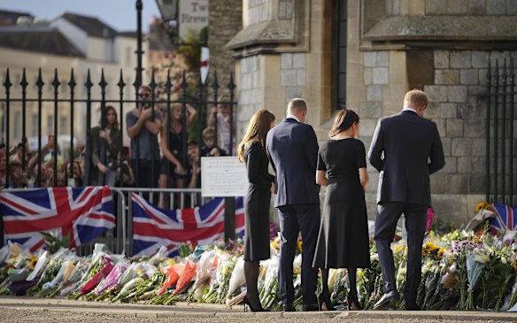 Britain's Prince William and Kate, Princess of Wales and Britain's Prince Harry and Meghan, Duchess of Sussex view the floral tributes for the late Queen Elizabeth II outside Windsor Castle.