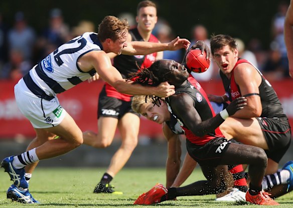 McDonald-Tipungwuti is tackled high by Cats' Mitch Duncan during this year's NAB Challenge match.