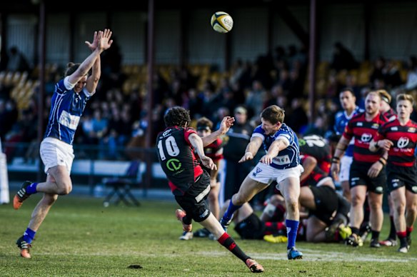 Royals' Jason Swaintries to charge down a kick from Gungahlin's Dan Garner.