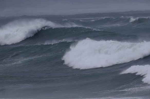 A kite surfer put it on the line at North Cronulla beach as big surf pounds the East coast.