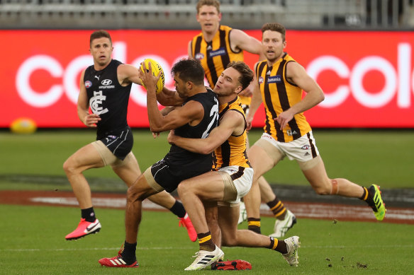 Gotcha: Hawthorn's Jack Scrimshaw gets his hands on Carlton's Jack Martin.