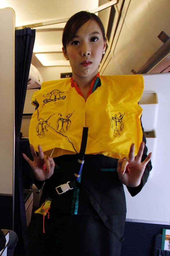 PC Air transsexual flight attendant Chayathisa Nakmai, 24, demonstrates in-flight safety to passengers.