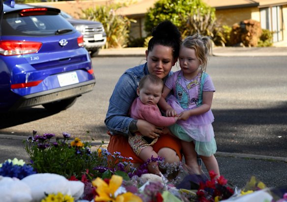 Flowers, plush toys and candles blanket the front lawn of Hillcrest Primary School.