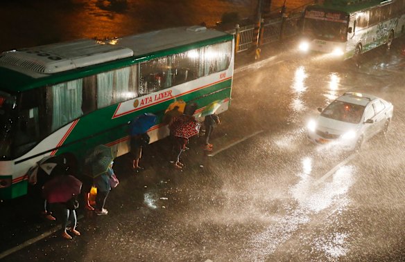 Commuters brave the rain and strong winds brought about by Typhoon Mangkhut which barrelled into northeastern Philippines before dawn Saturday.